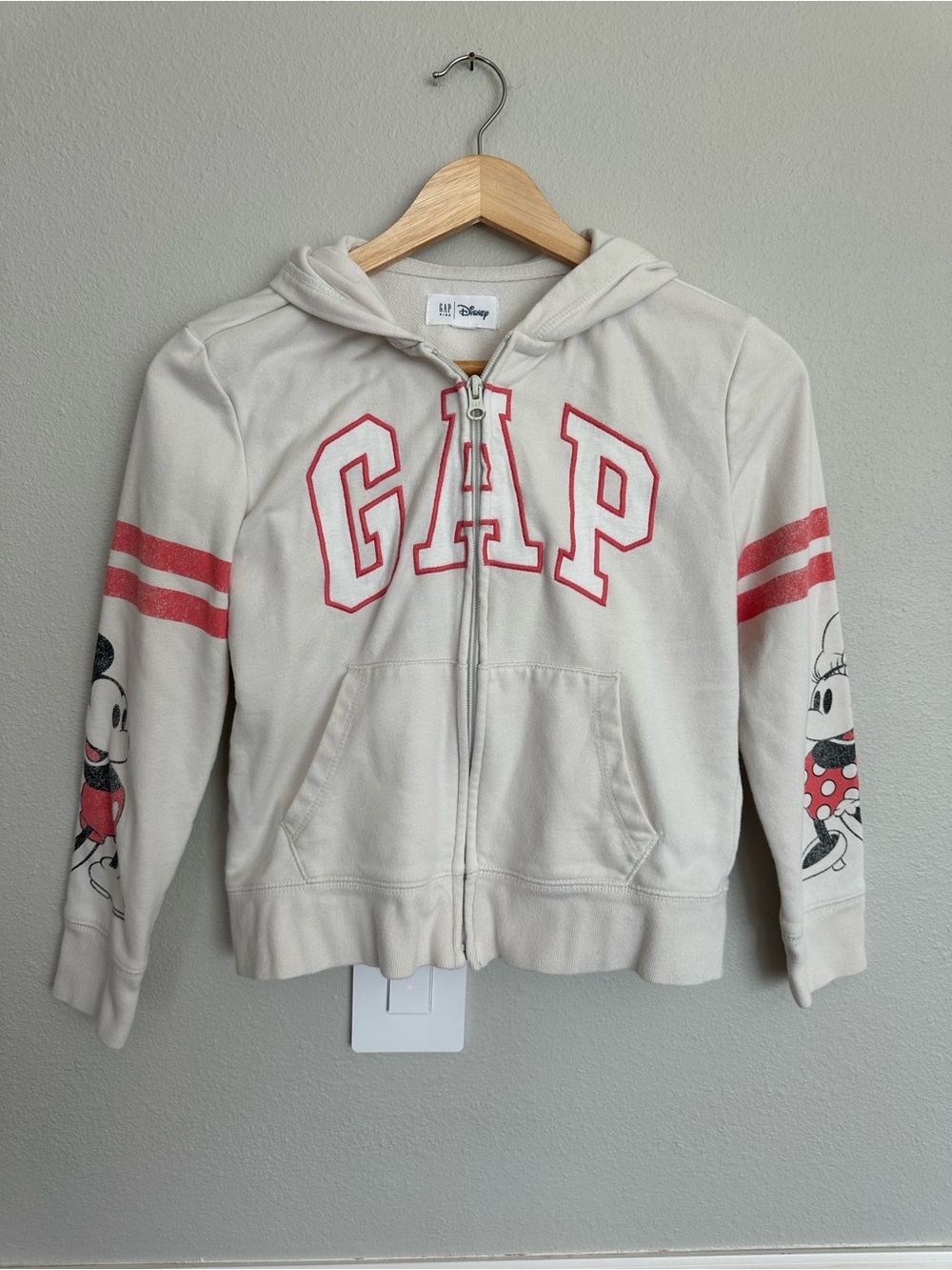 Girl’s GAP Disney Cream Zip Hoodie with Pink Lettering and Character Sleeves